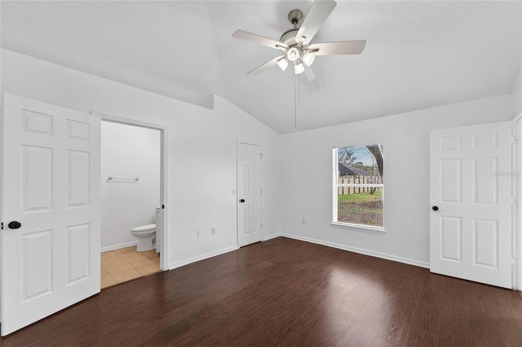 9010 Mc Cormick Street Spring Hill, FL 34608 - Photo 35 of 73 a view of an empty room with a window and wooden floor