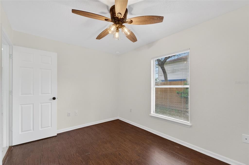 9010 Mc Cormick Street Spring Hill, FL 34608 - Photo 49 of 73 an empty room with windows and fan
