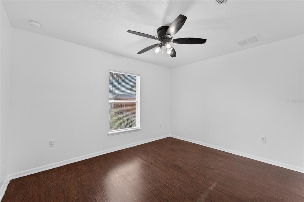 9010 Mc Cormick Street Spring Hill, FL 34608 - Photo 51 of 73 an empty room with wooden floor closet and windows