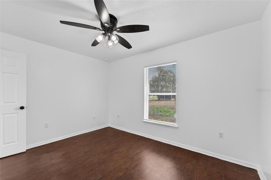 9010 Mc Cormick Street Spring Hill, FL 34608 - Photo 53 of 73 wooden floor in an empty room with a window