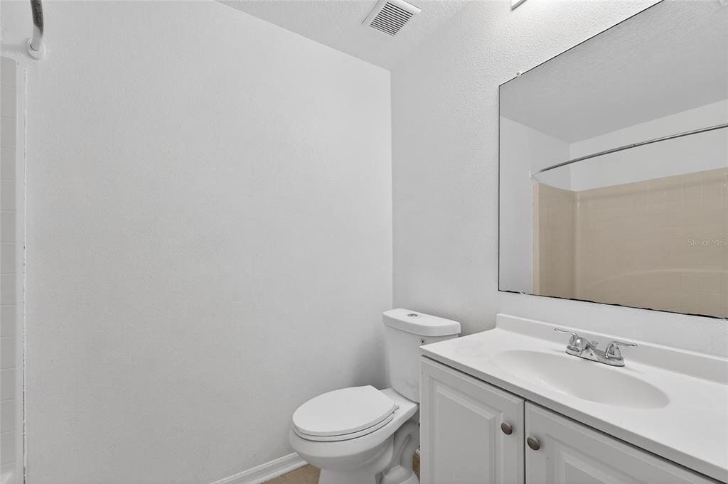 9010 Mc Cormick Street Spring Hill, FL 34608 - Photo 58 of 73 a bathroom with a sink a toilet and a mirror