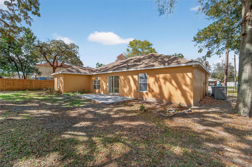 9010 Mc Cormick Street Spring Hill, FL 34608 - Photo 63 of 73 a view of a house with a yard