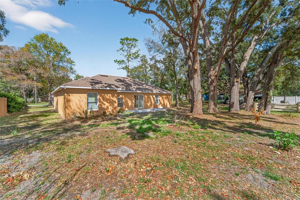 9010 Mc Cormick Street Spring Hill, FL 34608 - Photo 66 of 73 a view of a house with a yard