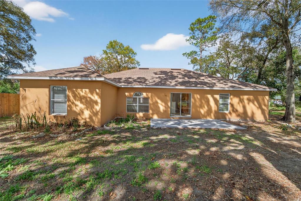 9010 Mc Cormick Street Spring Hill, FL 34608 - Photo 68 of 73 a front view of a house with a garden