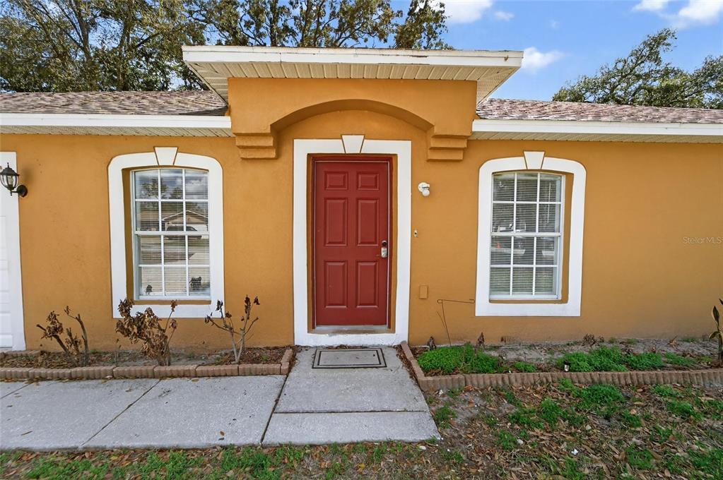 9010 Mc Cormick Street Spring Hill, FL 34608 - Photo 7 of 73 a front view of a house with a yard
