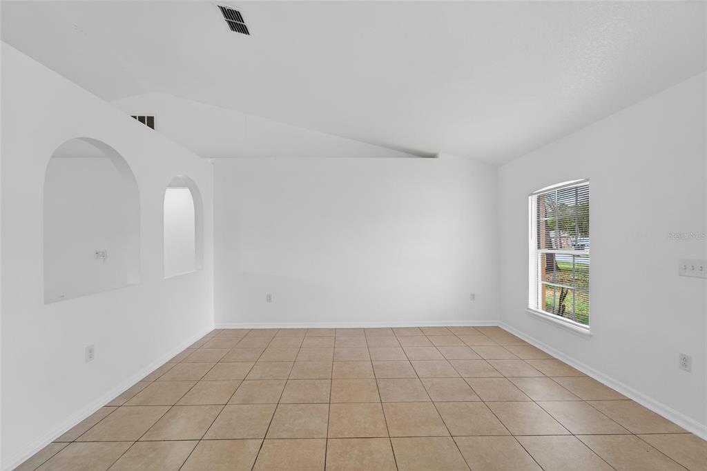 9010 Mc Cormick Street Spring Hill, FL 34608 - Photo 10 of 73 an empty room with windows
