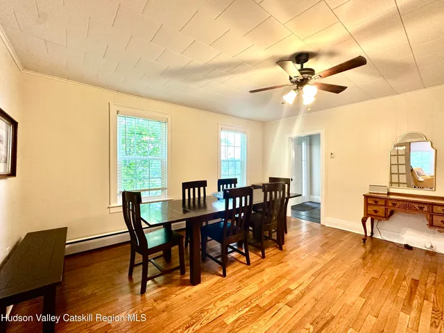 a view of a dining room with furniture window and wooden floor
