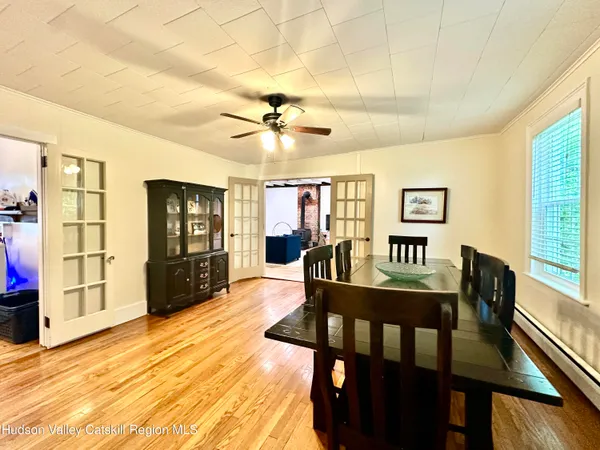 a view of a dining room with furniture and a window
