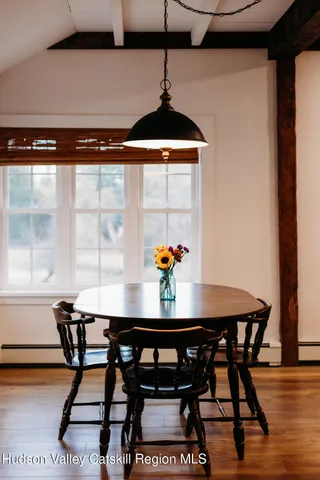 a view of a dining room with furniture and wooden floor