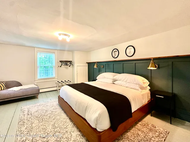 a bedroom with a bed and a couch