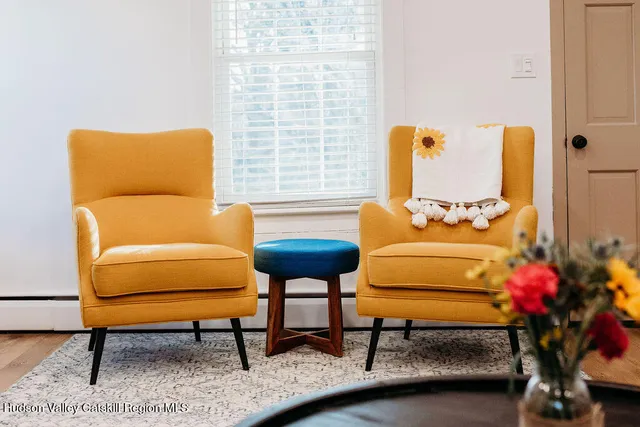 a living room with furniture and a potted plant