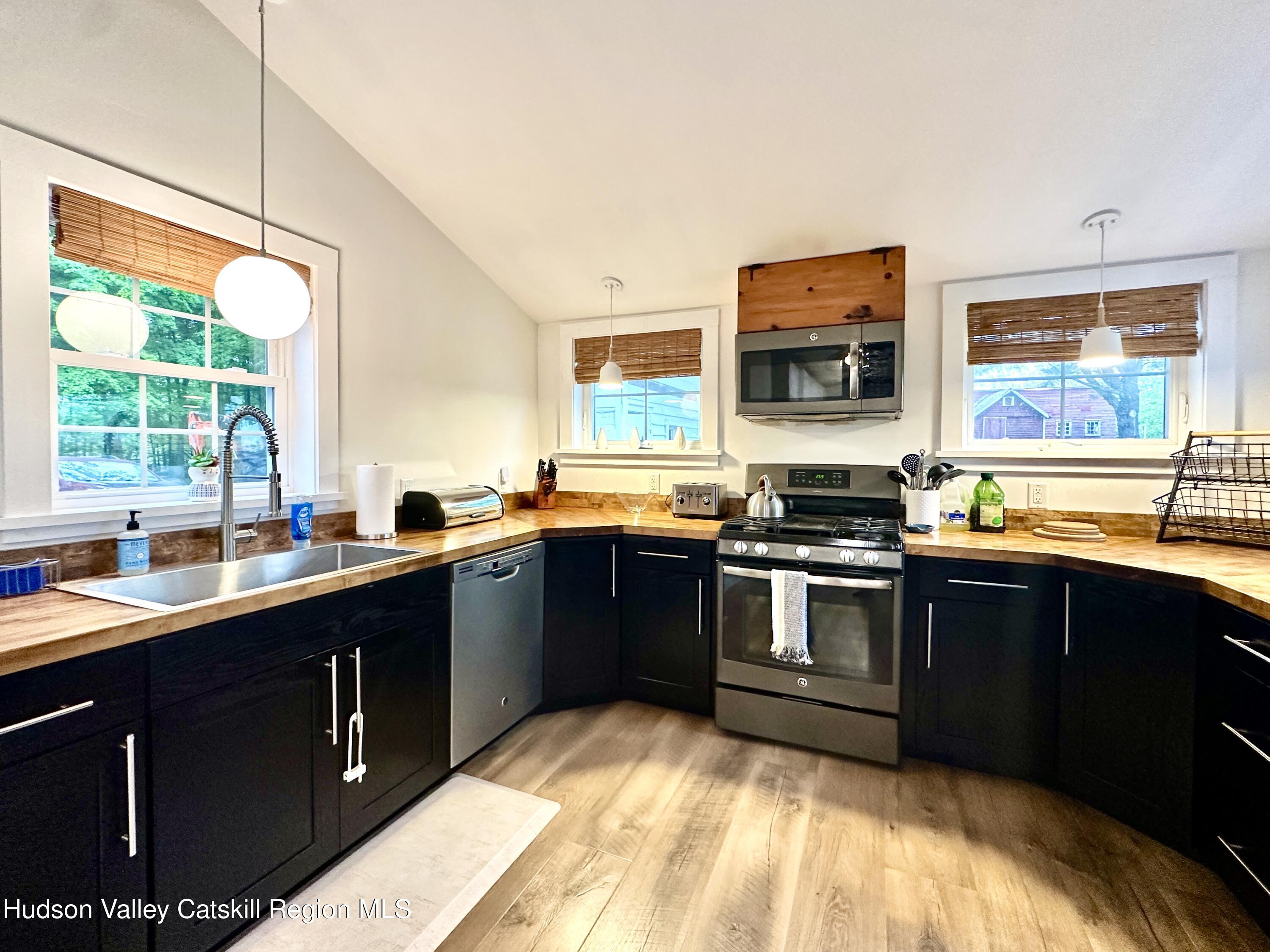 4028 County Rte 26 Greenville, NY 12083 - Photo 3 of 51 a kitchen with stainless steel appliances granite countertop a sink stove and refrigerator