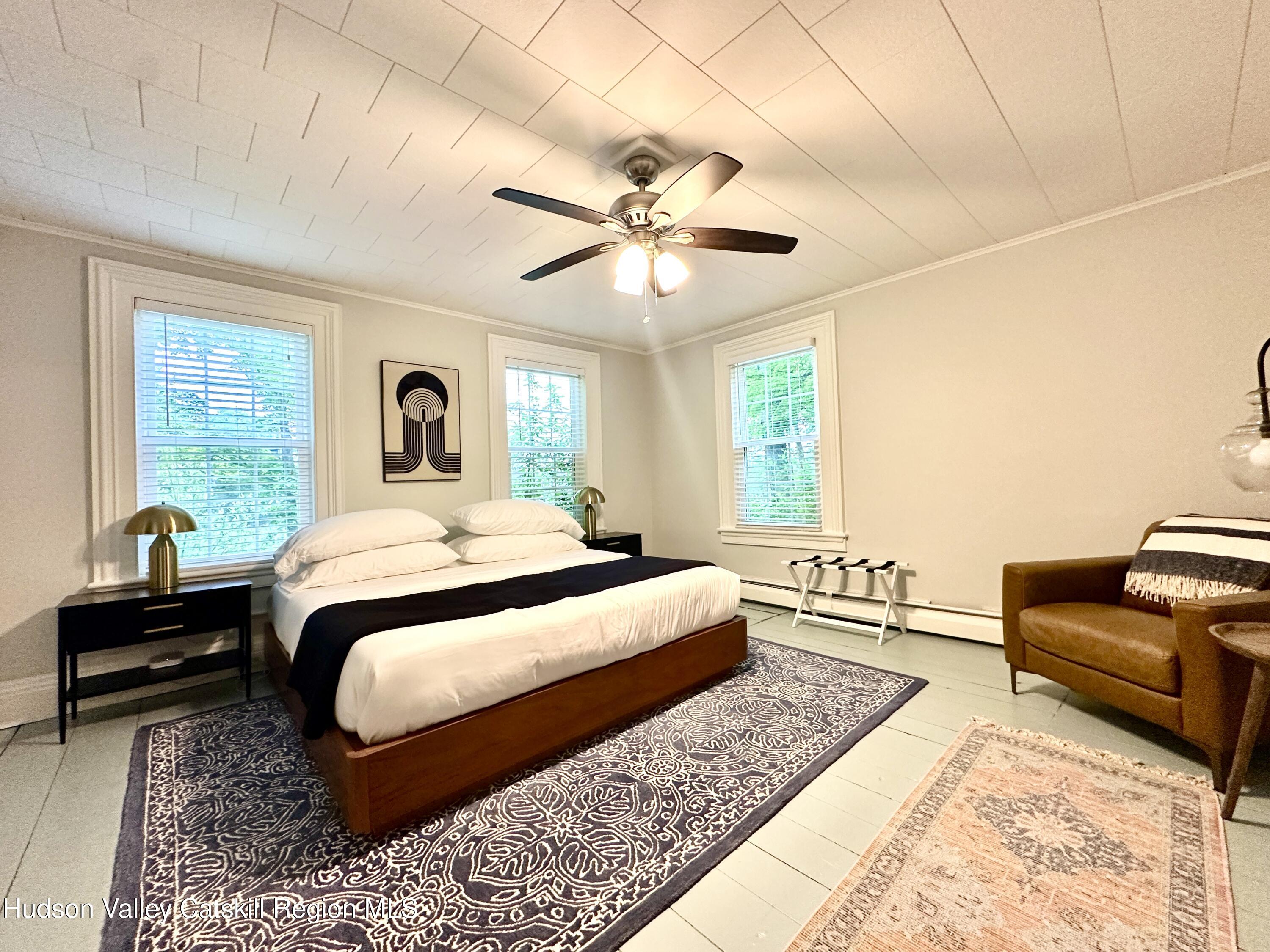 4028 County Rte 26 Greenville, NY 12083 - Photo 34 of 51 a bedroom with a large bed and a couch