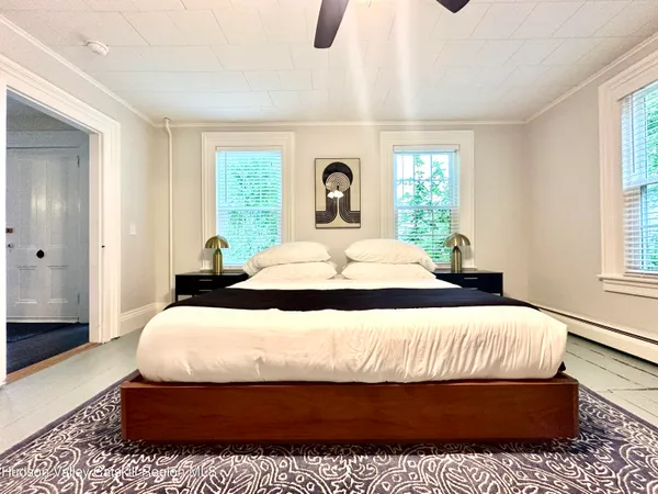 a bedroom with furniture and a window