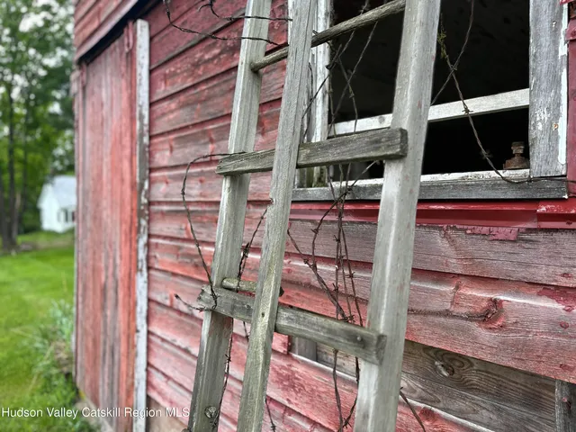 a backyard of a house with a wooden bench