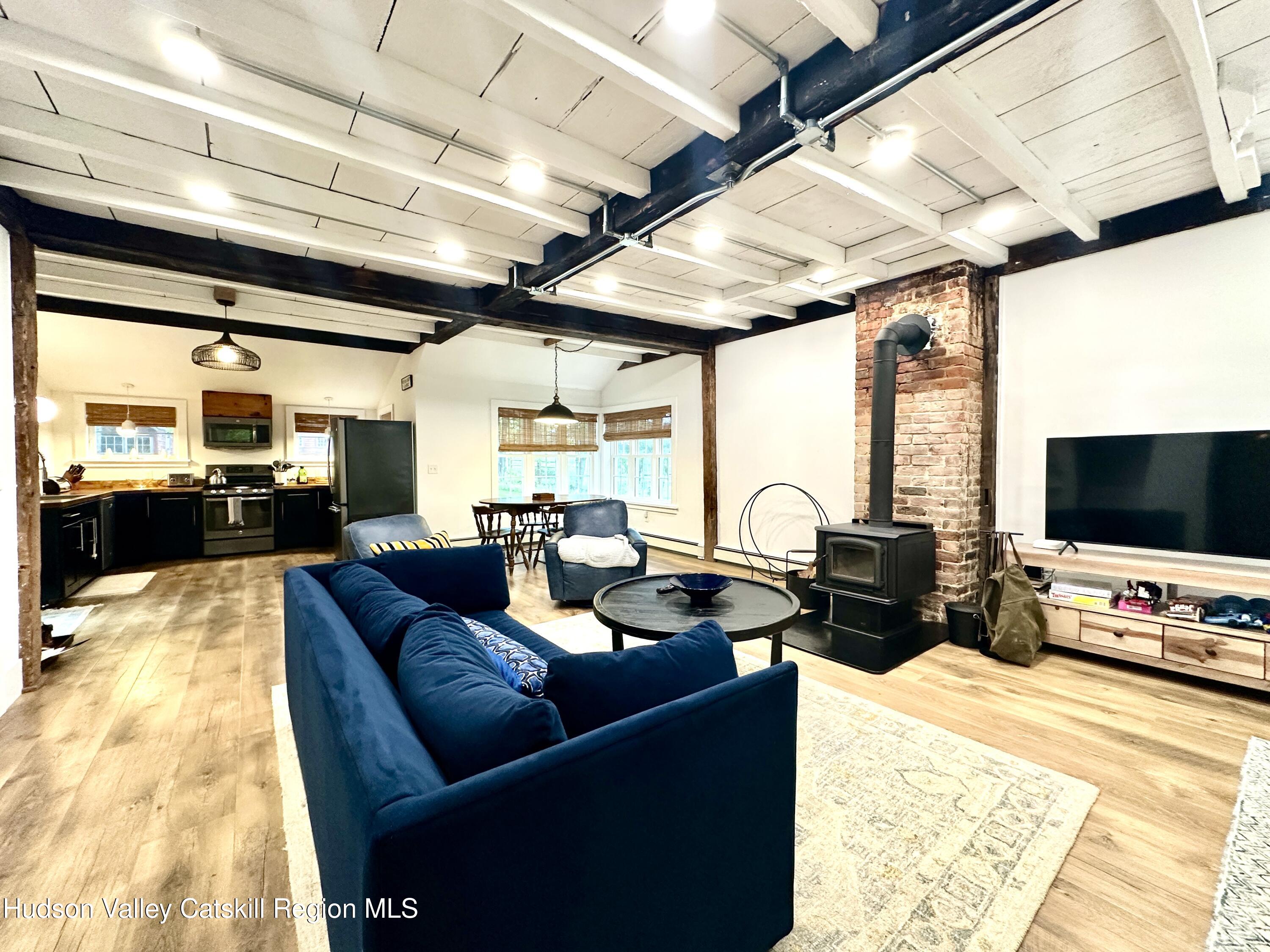 4028 County Rte 26 Greenville, NY 12083 - Photo 7 of 51 a living room with furniture and a flat screen tv