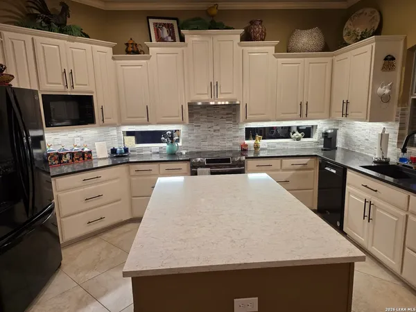 a kitchen with refrigerator and window