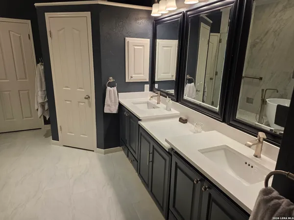 a bedroom with a bed and a large mirror