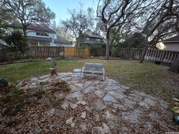 a view of backyard with deck and seating space