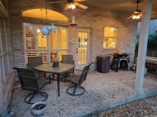 a view of a lounge chairs in the back yard of the house