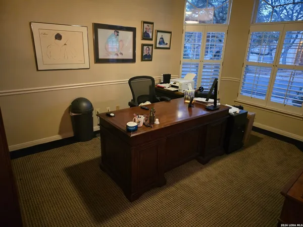 a room with furniture and wall paintings