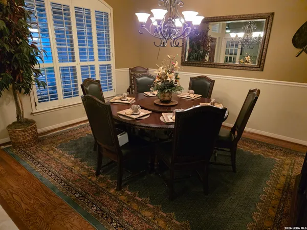 a view of a dining room with furniture and chandelier