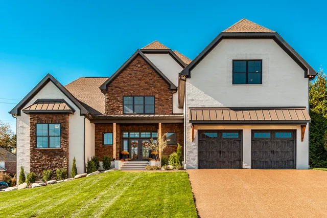 a view of a house with a yard and porch