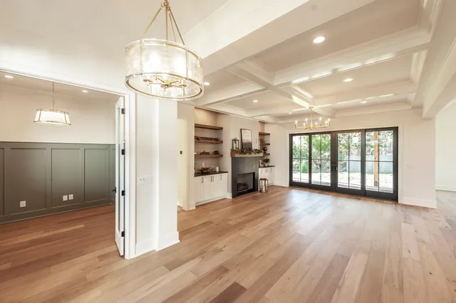 a kitchen with stainless steel appliances a stove a sink a refrigerator and wooden floor