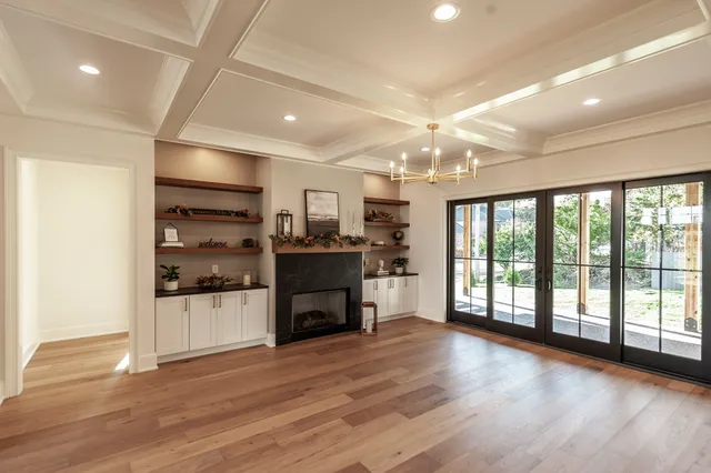 a kitchen with stainless steel appliances kitchen island granite countertop a sink a stove and a wooden floors