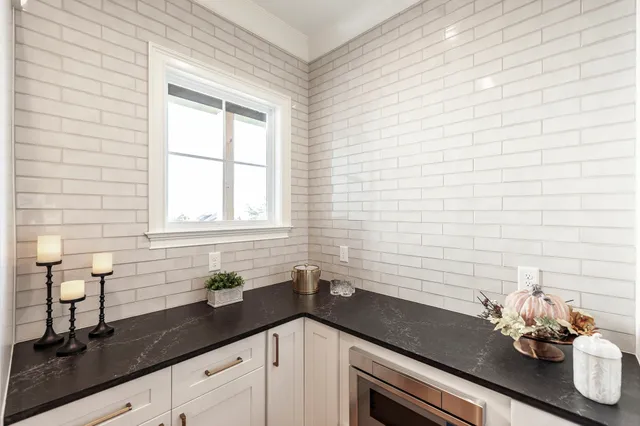 a view of a kitchen with sink and wooden floor