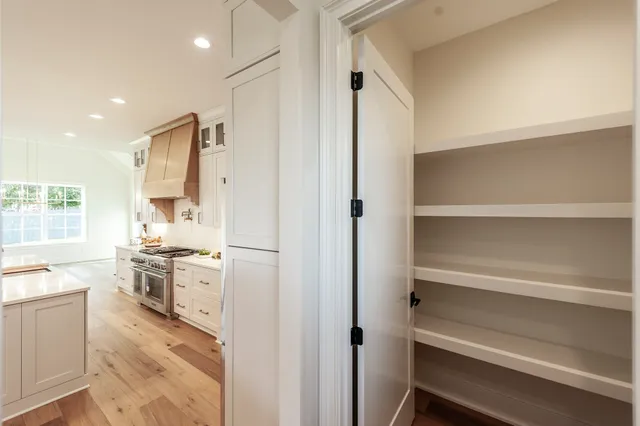 a view of an empty room and wooden floor