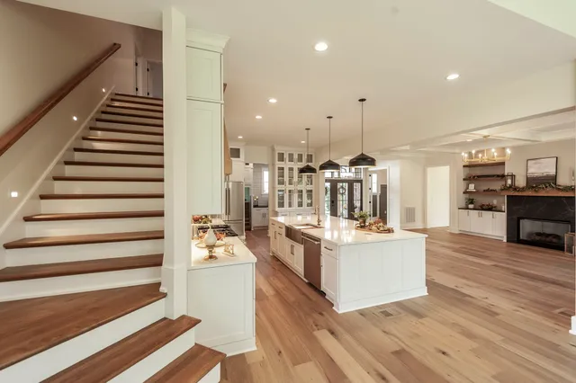 an empty room with wooden floor and window