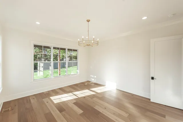 an empty room with a empty space and windows