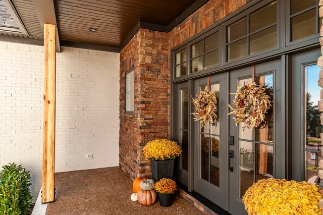 a large white kitchen with granite countertop a large counter top appliances and cabinets