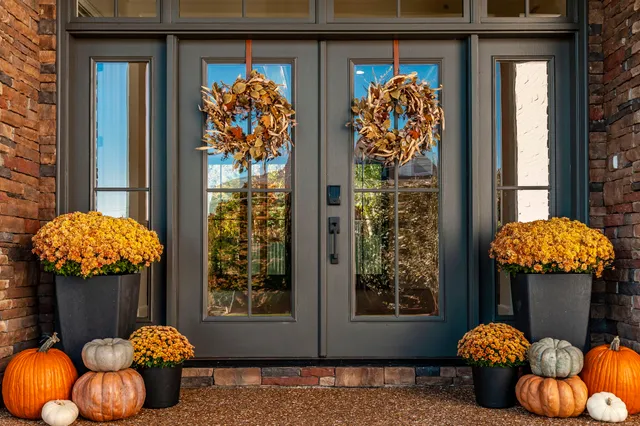a kitchen with stainless steel appliances kitchen island granite countertop a sink a stove and a wooden floors