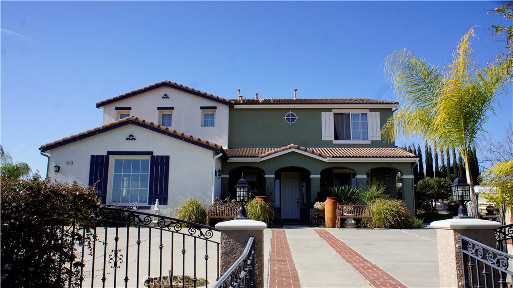 a front view of house with yard and trees in the background