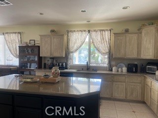 18689 Hawkhill Avenue Perris, CA 92570 - Photo 14 of 52 a kitchen with sink a window and cabinets