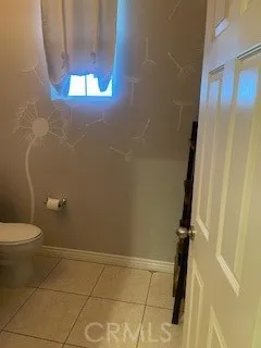 a bathroom with a granite countertop shower and a toilet