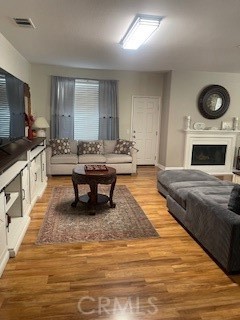 18689 Hawkhill Avenue Perris, CA 92570 - Photo 22 of 52 a living room with furniture and a fireplace