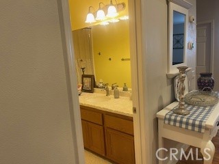 18689 Hawkhill Avenue Perris, CA 92570 - Photo 33 of 52 a en suite bathroom with a sink and mirror with shower