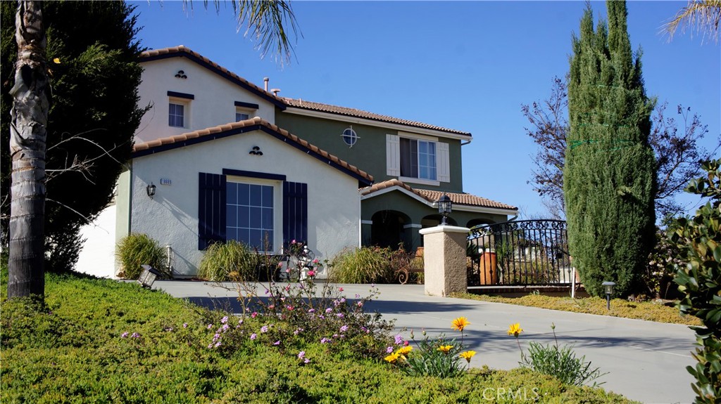 18689 Hawkhill Avenue Perris, CA 92570 - Photo 4 of 52 a front view of a house with a yard