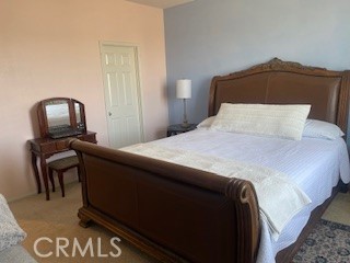 18689 Hawkhill Avenue Perris, CA 92570 - Photo 42 of 52 a bedroom with a bed chair and mirror on dresser