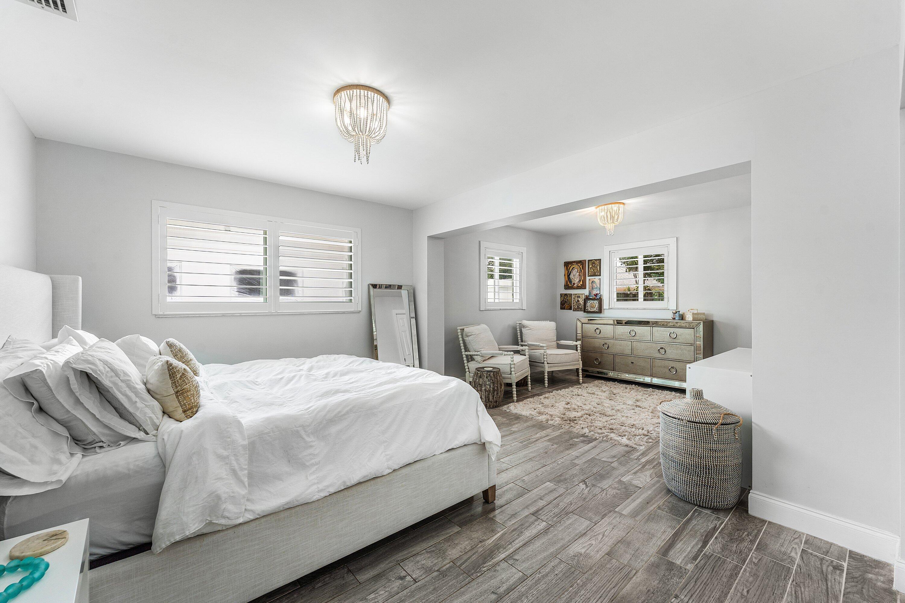 581 Northwest 13th Drive Boca Raton, FL 33486 - Photo 22 of 39 a bedroom with a bed and wooden floor