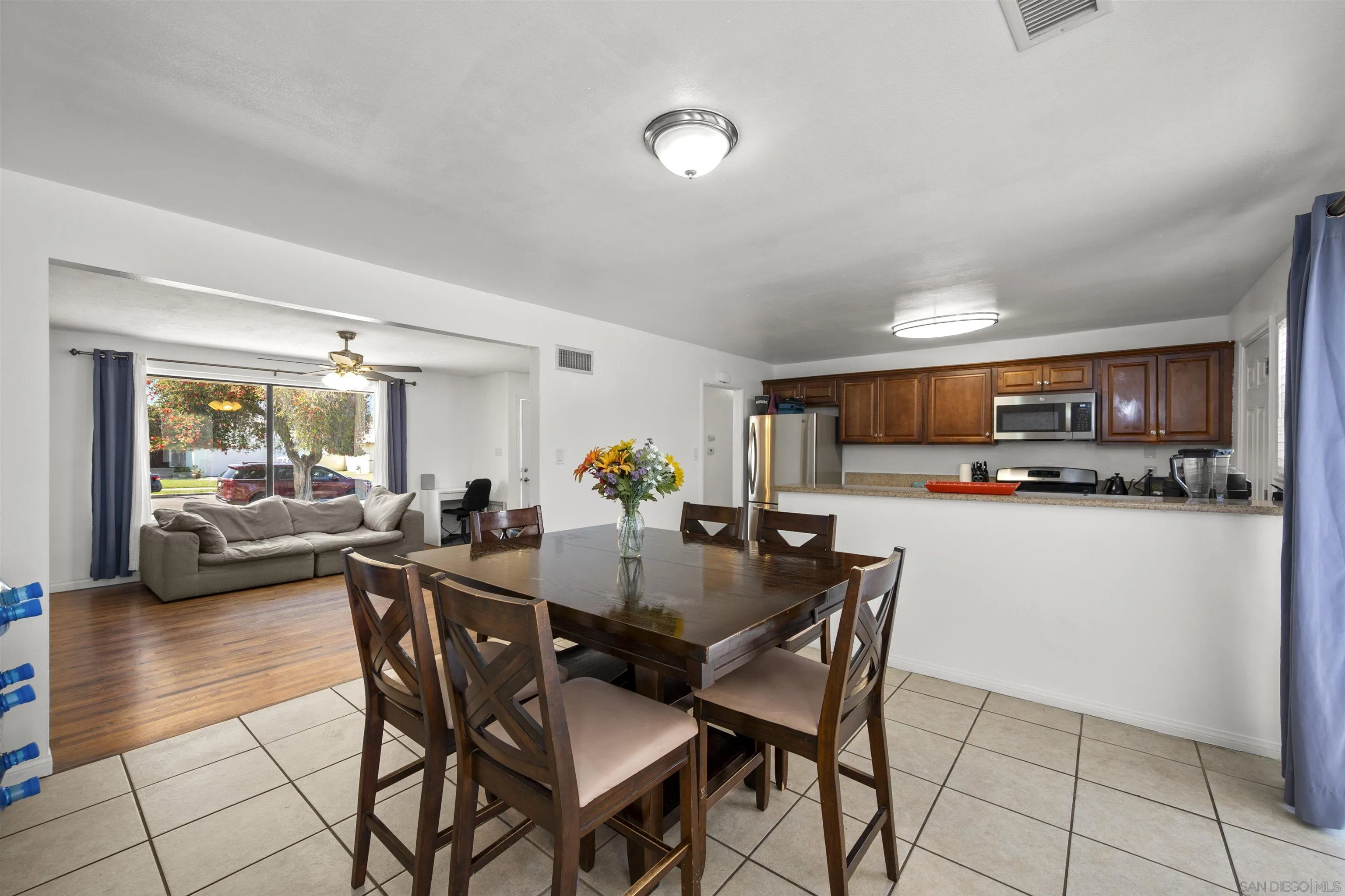 8740 Adriana Street Spring Valley, CA 91977 - Photo 12 of 32 a view of a dining room with furniture and a kitchen
