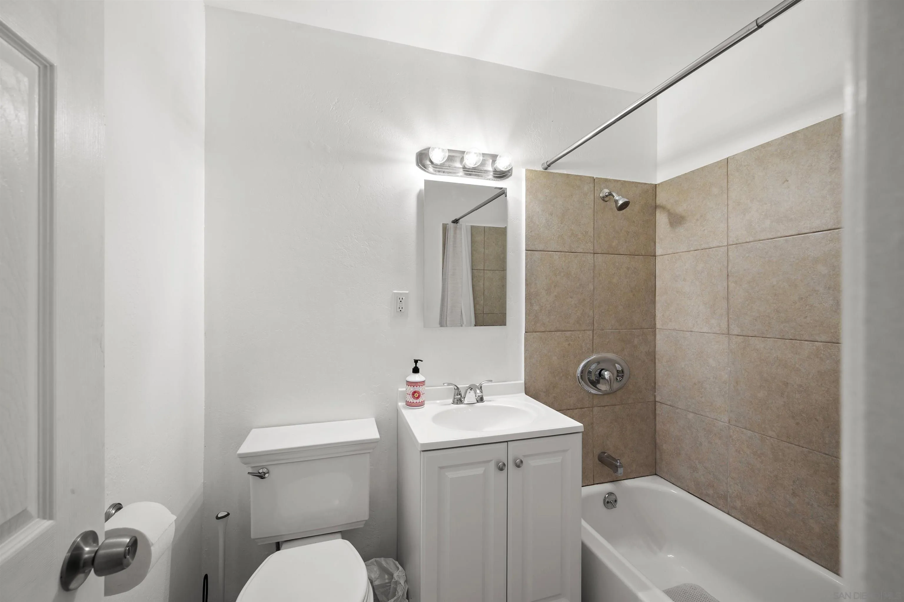 8740 Adriana Street Spring Valley, CA 91977 - Photo 16 of 32 a bathroom with a sink a toilet and shower