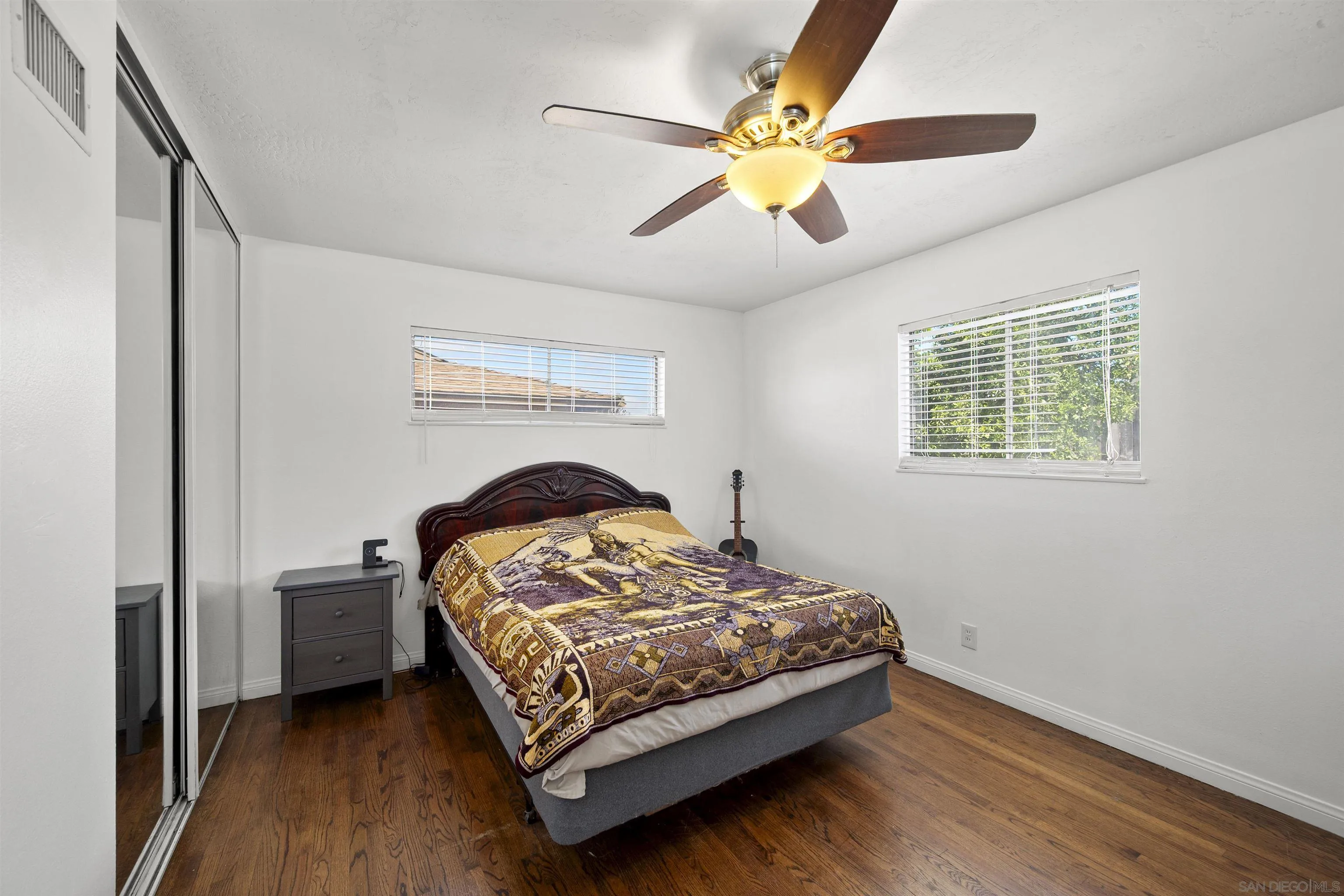 8740 Adriana Street Spring Valley, CA 91977 - Photo 17 of 32 a bedroom with a bed and a chandelier