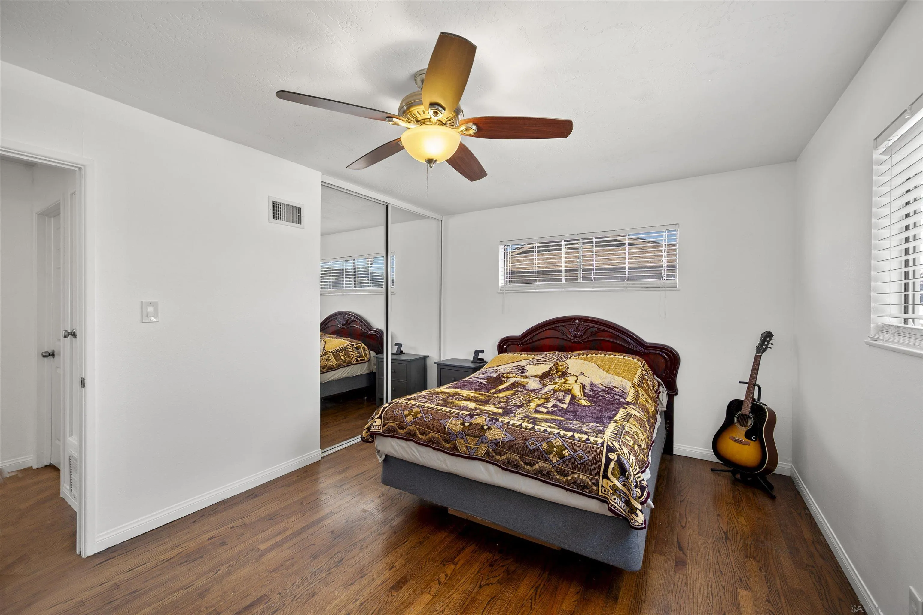 8740 Adriana Street Spring Valley, CA 91977 - Photo 18 of 32 a bedroom with a bed and window