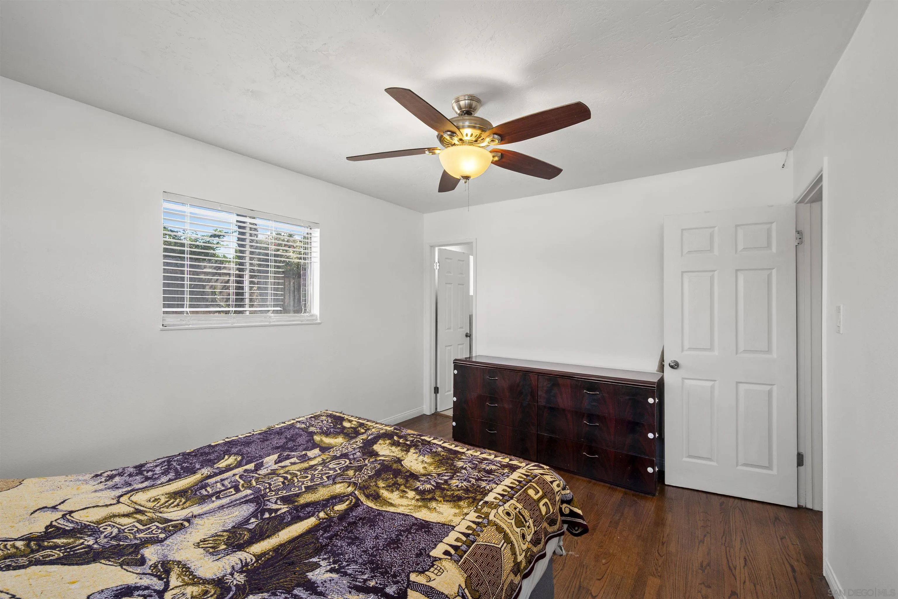 8740 Adriana Street Spring Valley, CA 91977 - Photo 19 of 32 a bedroom with a bed and a dresser
