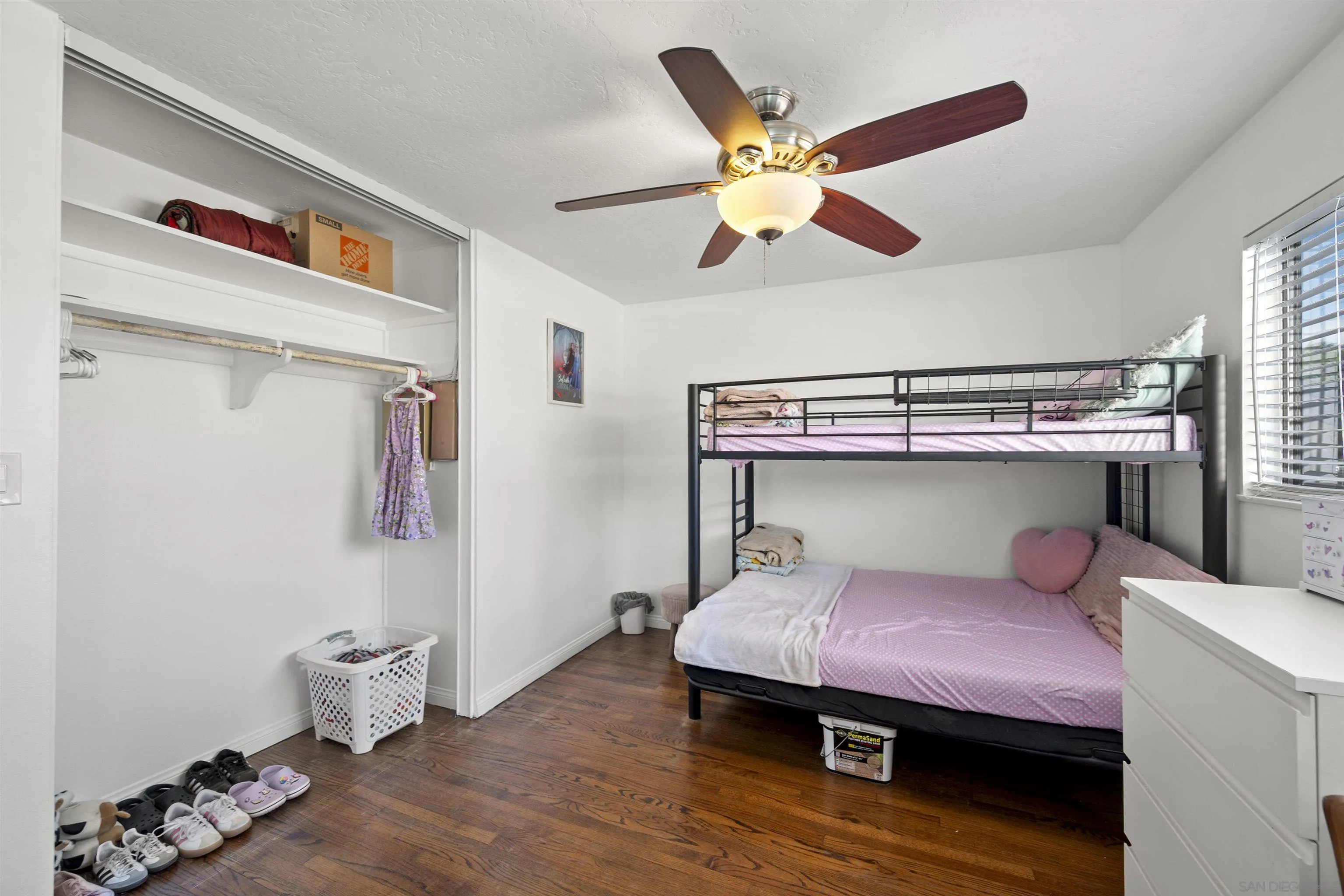 8740 Adriana Street Spring Valley, CA 91977 - Photo 22 of 32 a bedroom with a bed and wooden floor