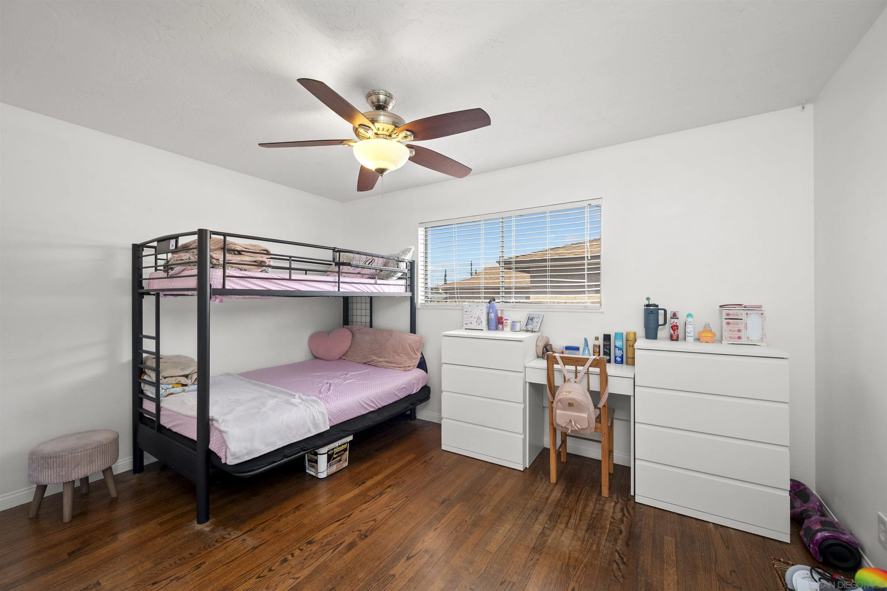 8740 Adriana Street Spring Valley, CA 91977 - Photo 23 of 32 a bedroom with a bed and a desk